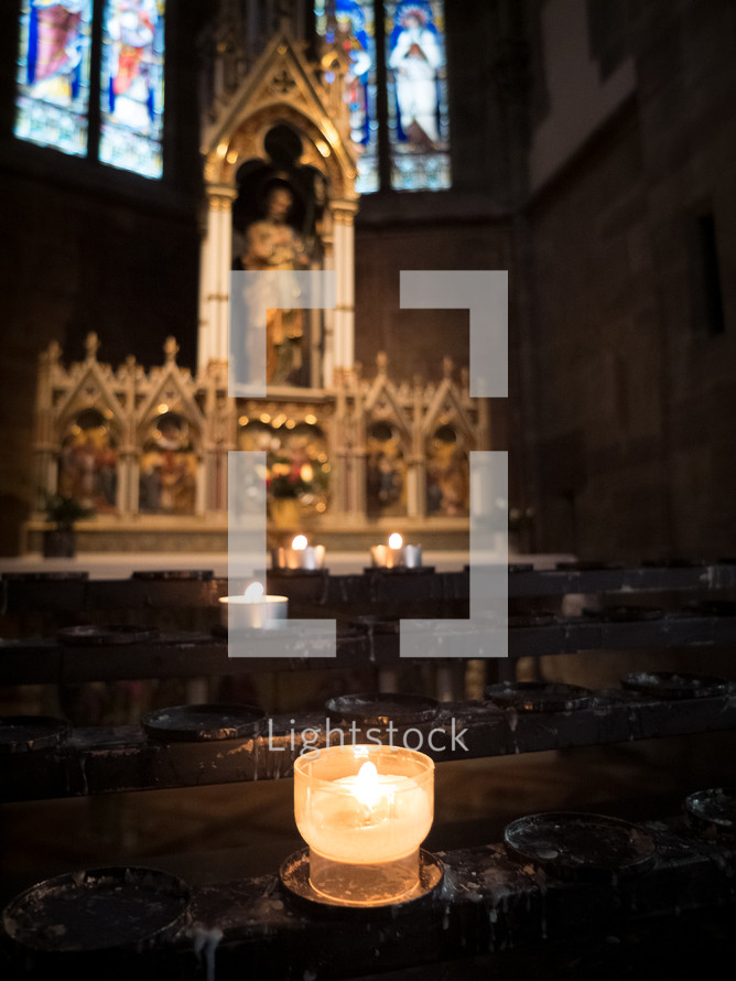 prayer candles at an altar 