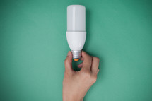 hand holding a lightbulb 