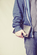 man carrying a Bible at his side