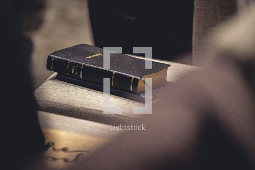 Bible sitting on a chair in a church worship service.