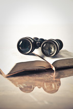 binoculars on a Bible