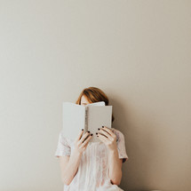 A woman reading a book about creativity