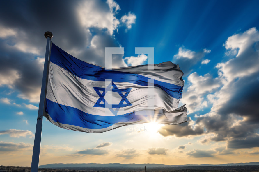 The flag of the nation Israel blowing the wind at dawn with the sun setting on the horizon. 