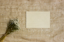 bouquet of flowers, stationary, an envelope on linen 