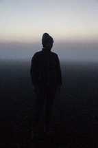 a woman standing outdoors in fog in Iceland 
