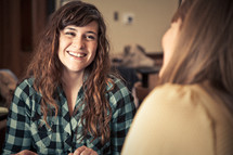 smiling young women discussing scripture at a Bible study