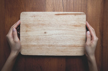 hands on a cutting board 