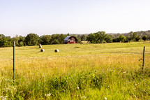 red barn and hay bales 