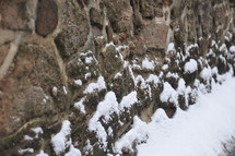 snow on a stone wall 