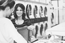 women doing laundry in a laundromat