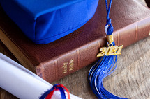 graduation cap and diploma on a Bible 