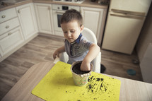 kid planting seeds in a kitchen 