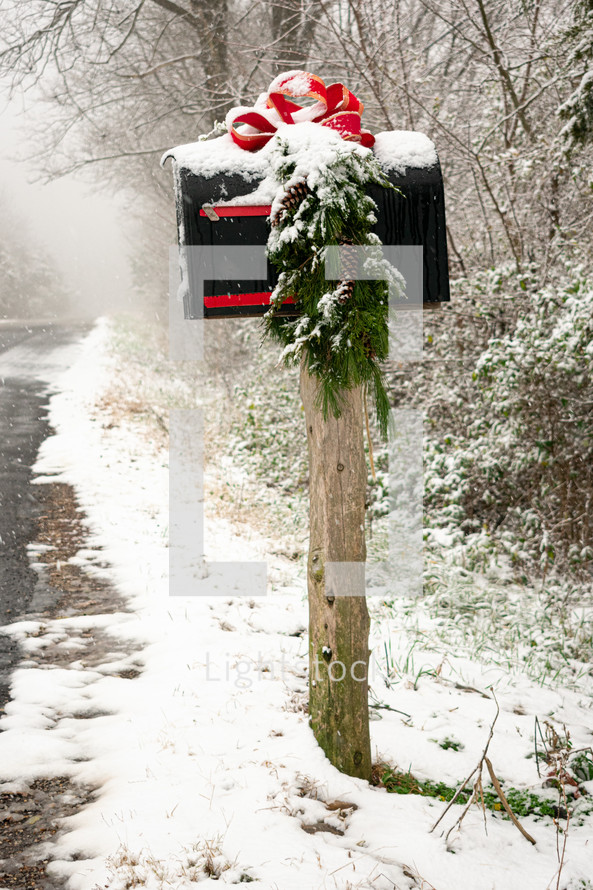 snow on a mailbox decorated for Christmas 