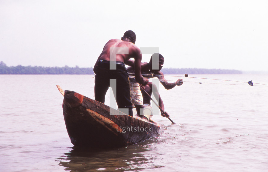 fishermen in a wooden boat 