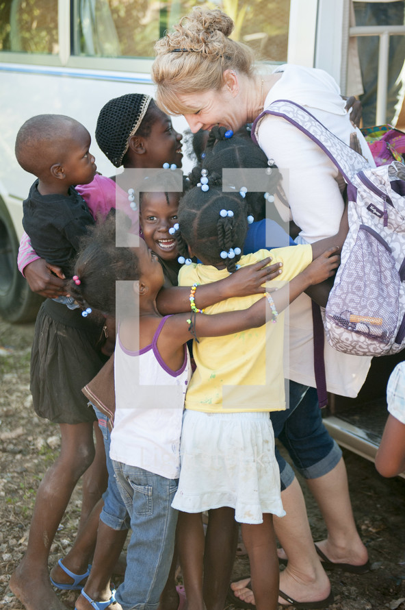 a missionary hugging children in the Dominican Republic