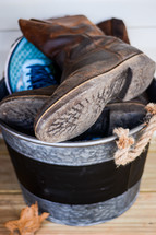 shoes and boots in a tin bucket 