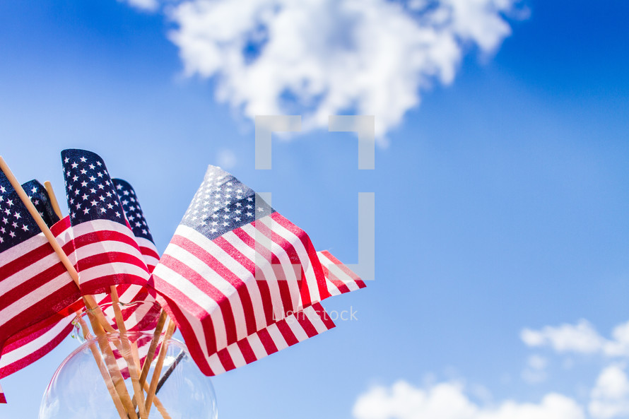 American flags in a vase and blue sky 