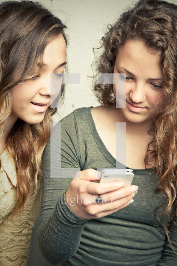 Teenage girls looking at smart phone.