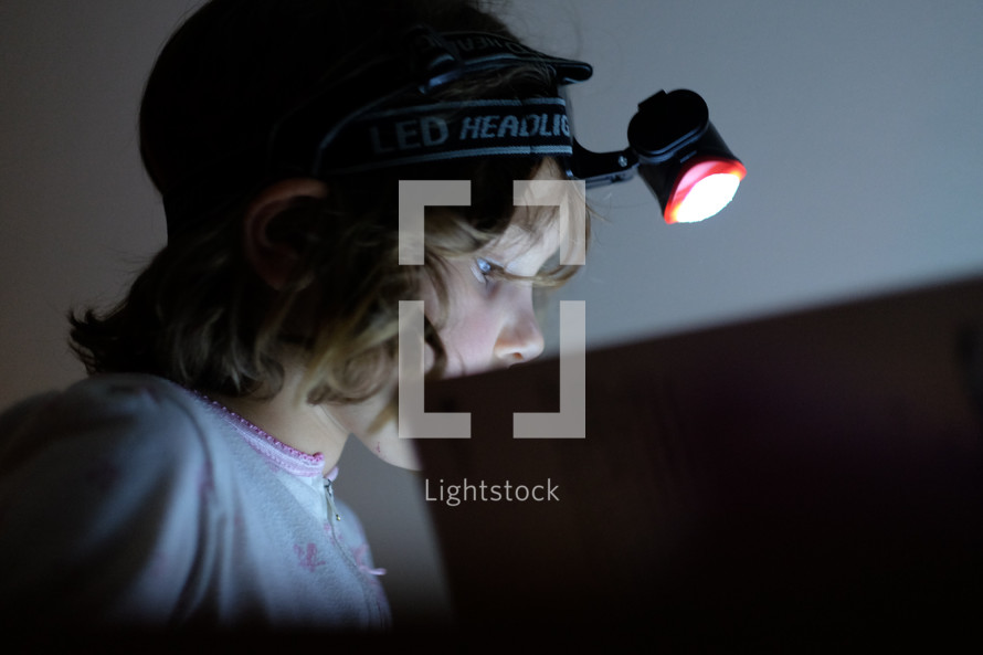 a child wearing a headlamp 