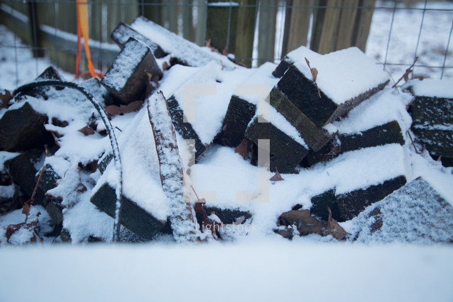 snow on a wood pile 