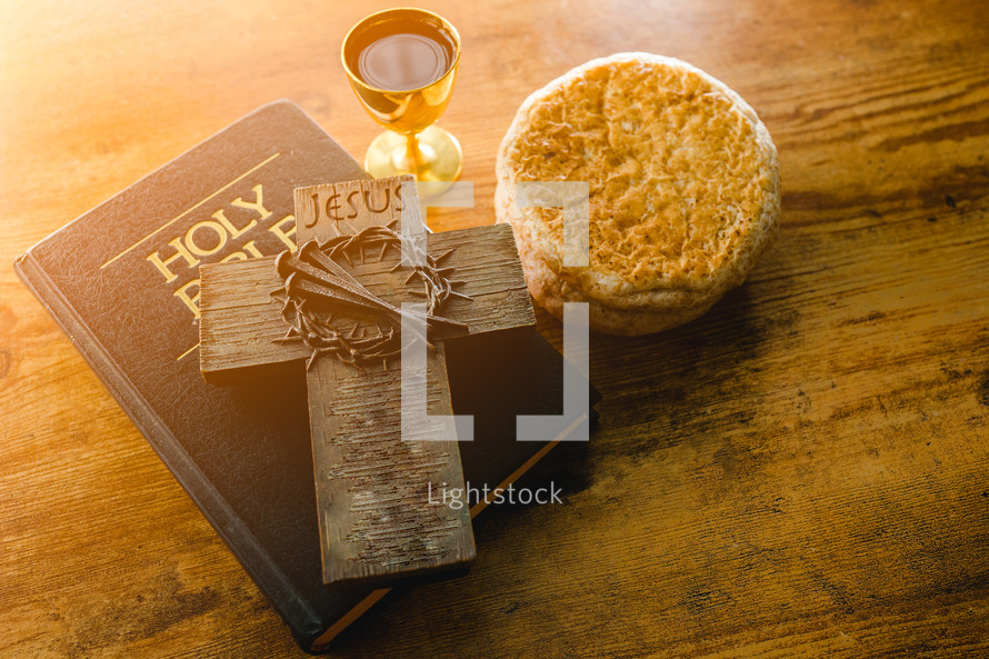 communion bread and wine with Bible and cross 