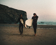 surfers on a beach 