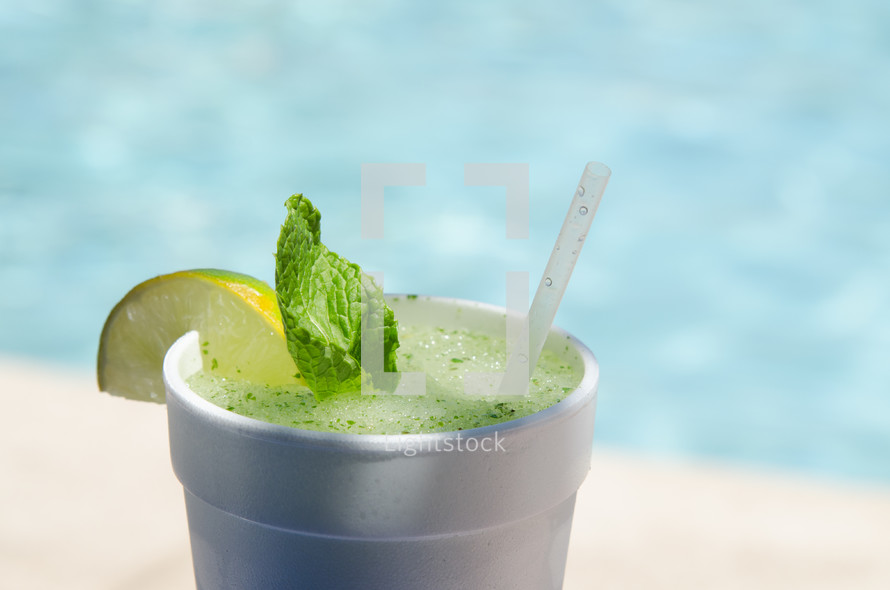 Cup of mint lemonade at the beach.