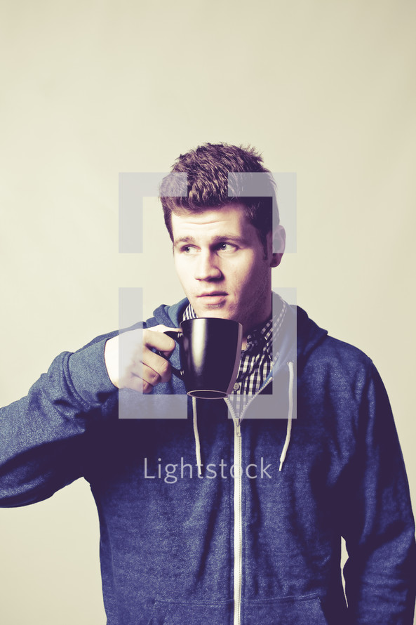 man drinking from a coffee mug