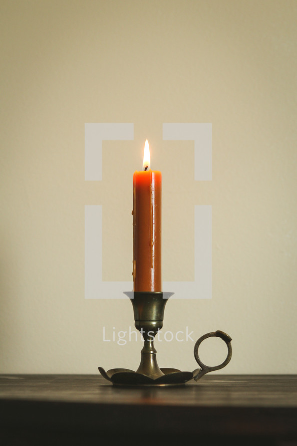 burning orange candlestick 