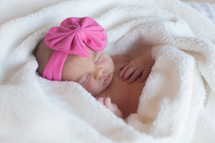 a sleeping newborn girl 