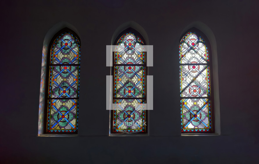 A stunningly painted stained glass window inside a historic church building. 