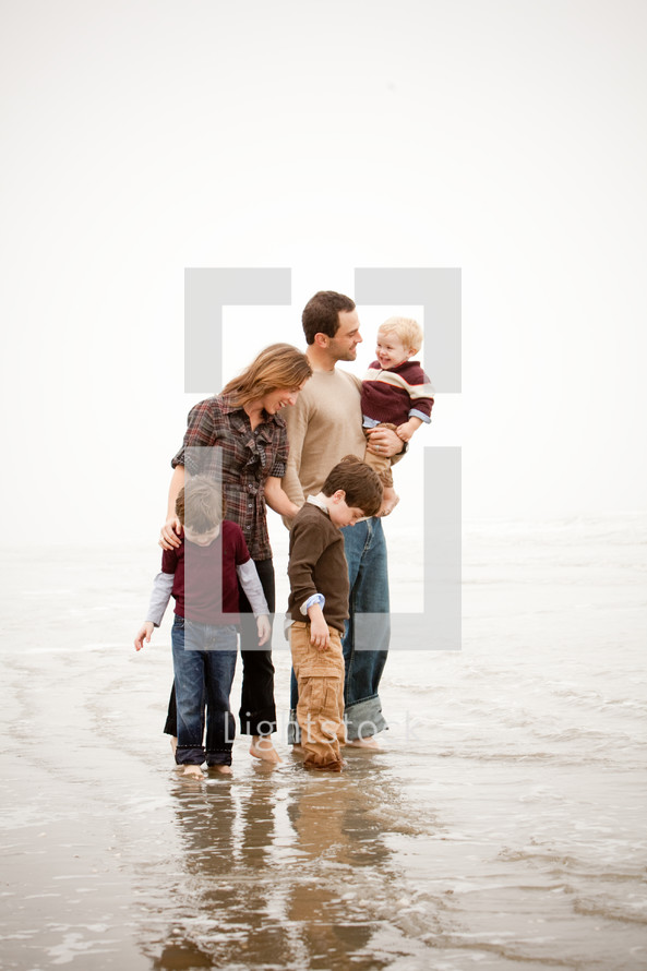 a family standing in the tide 