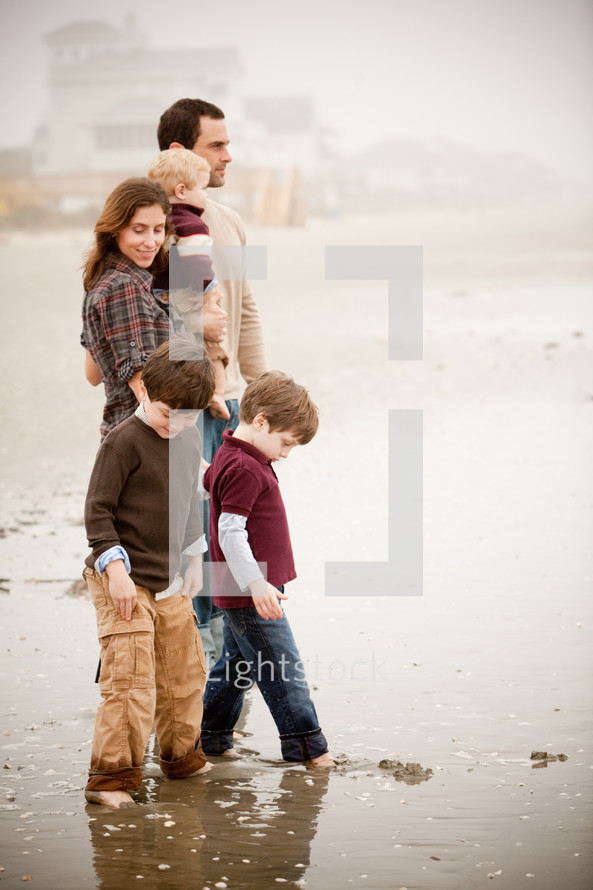 a family standing on a beach 