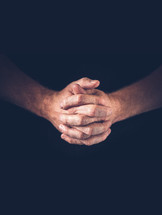 A vertical shoot of hands closed in prayer