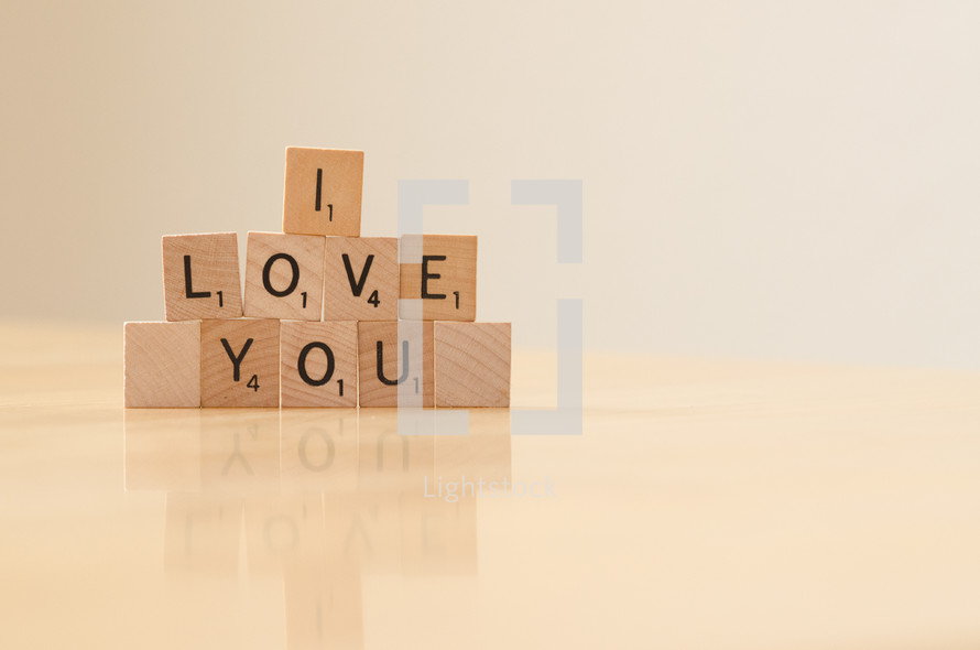 " I love you" spelled out in stacked scrabble tiles