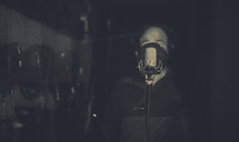 man singing into a microphone in a recording studio 