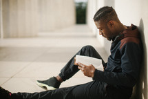 African American man sitting reading a Bible 