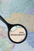 magnifying glass over a map of Afghanistan 