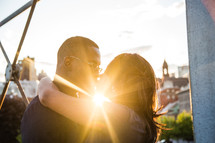 An African American couple kissing and a sunburst 