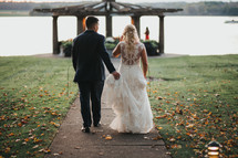 bride and groom walking down a sidewalk 