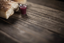 Communion bread and wine on wood.