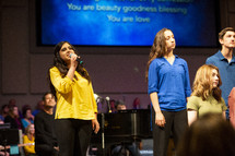 girls singing during a worship service 