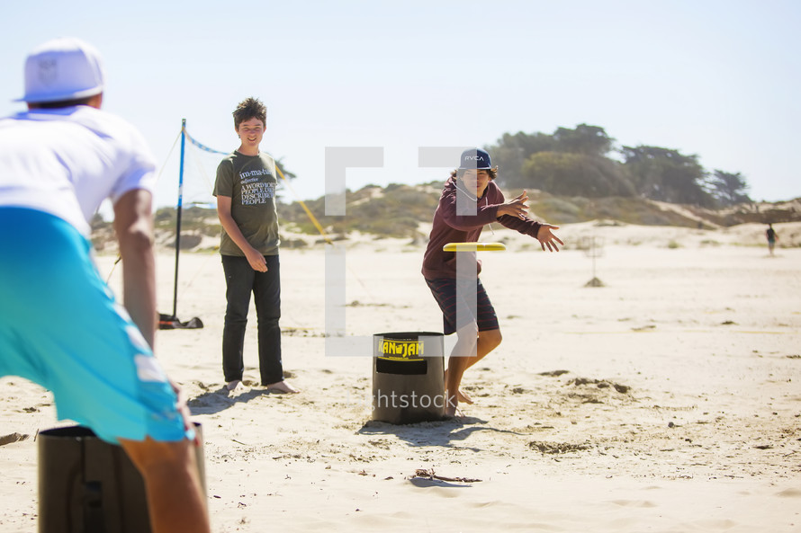 teens playing on a beach 