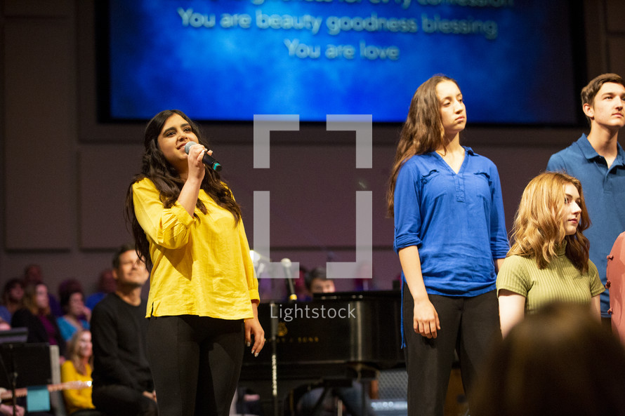 girls singing during a worship service 