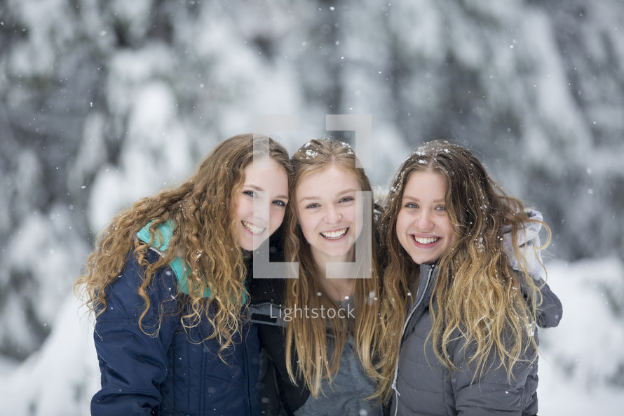 smiling women in falling snow 