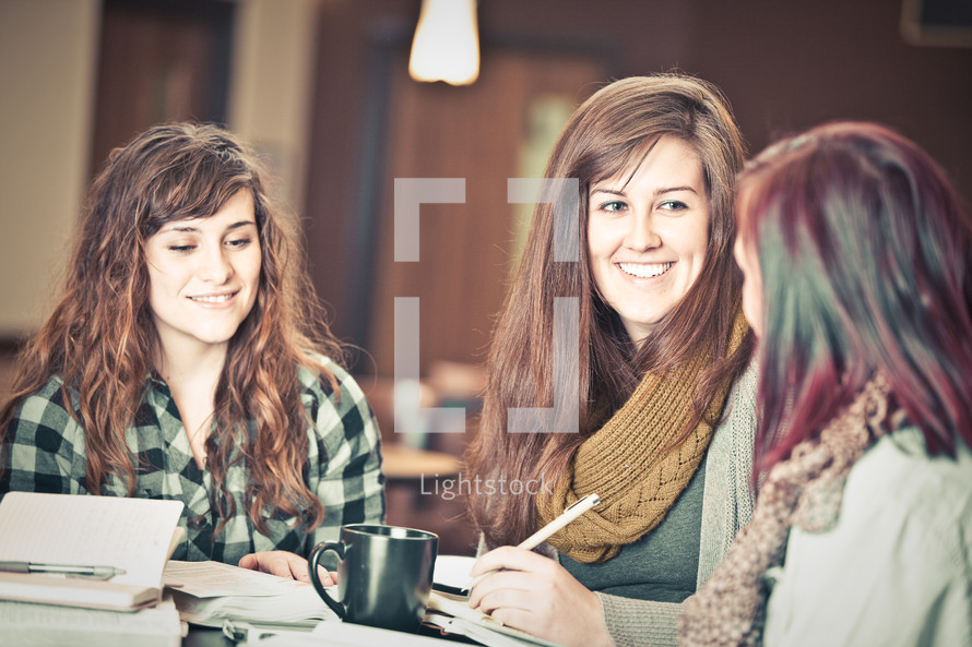 young women reading and discussing scripture at a Bible study