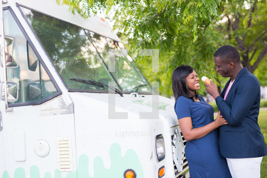 an African American couple in love eating ice cream 