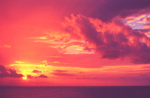fuchsia and violet sky at sunset over the ocean 