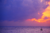 buoy in the ocean and purple sky at sunset 