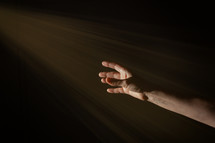 hand reaching towards light 